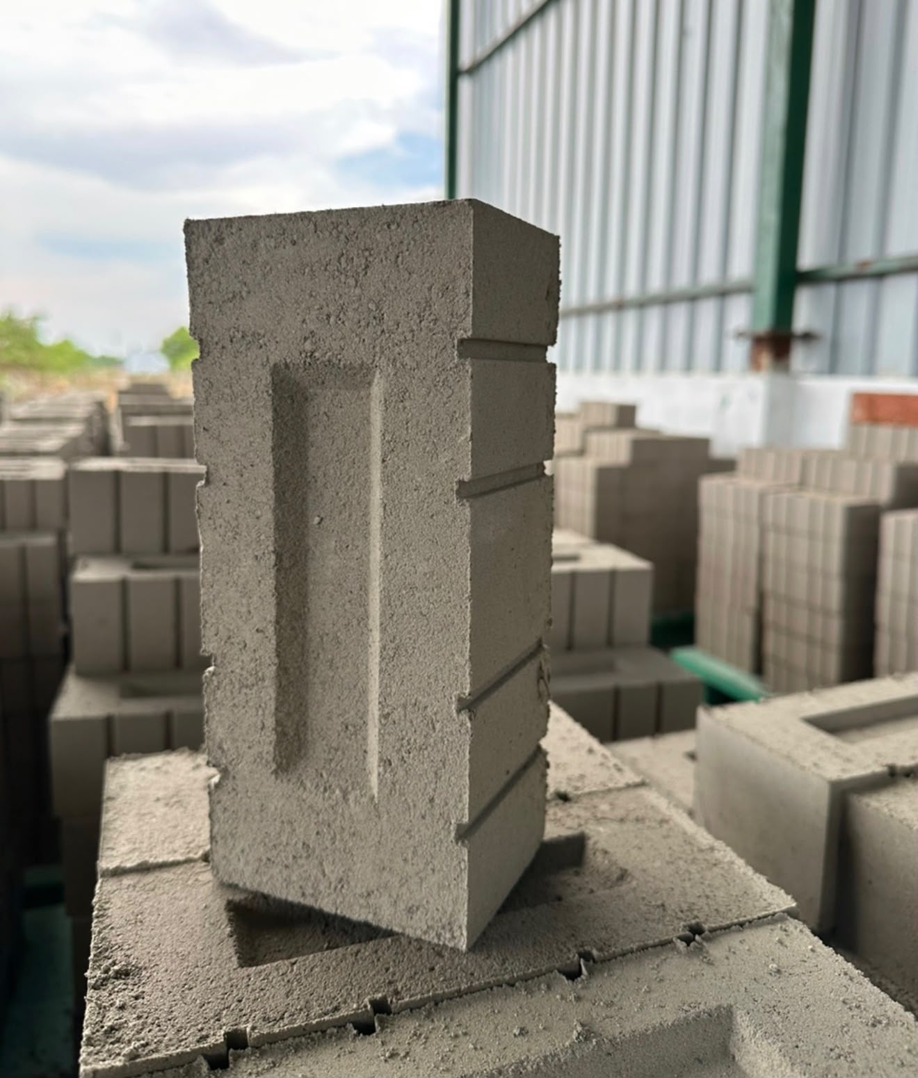 Single PMM fly ash brick showing its dense pressed body, sharp edges and clean frog